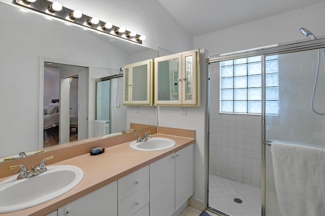 bathroom with walk in shower, vaulted ceiling, and vanity