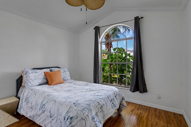 bedroom with ceiling fan, ornamental molding, lofted ceiling, and dark hardwood / wood-style flooring