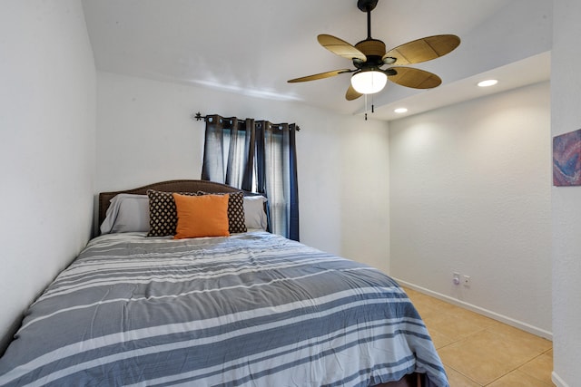 tiled bedroom featuring ceiling fan