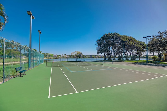 view of sport court featuring a water view