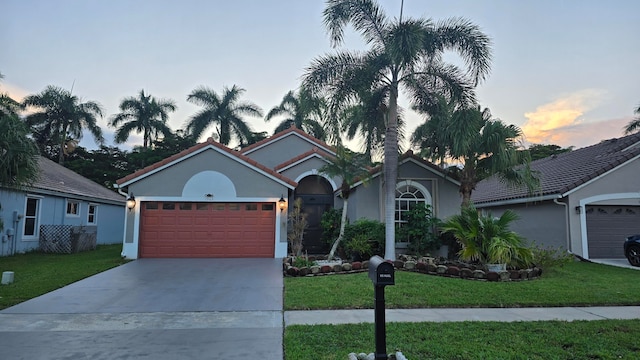 view of front facade with a lawn and a garage