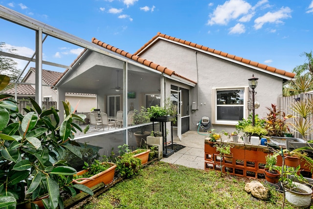 back of property with a lanai and a patio