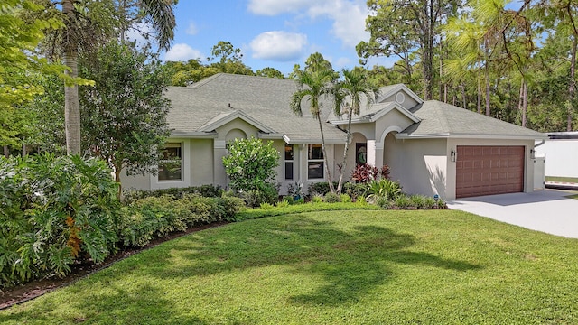 single story home featuring a garage and a front lawn