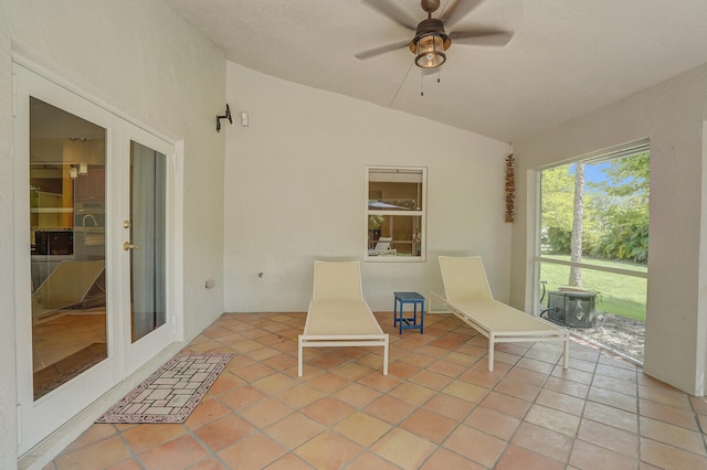 unfurnished sunroom with ceiling fan and lofted ceiling