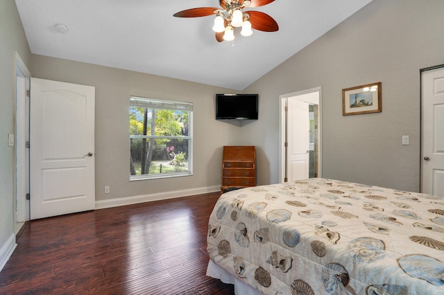 bedroom with ceiling fan, dark wood-type flooring, and vaulted ceiling