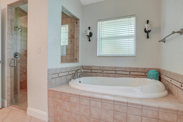 bathroom with tile patterned flooring and shower with separate bathtub