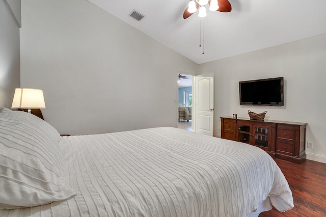 bedroom featuring dark wood-type flooring, vaulted ceiling, and ceiling fan