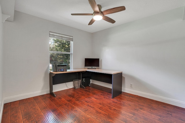 office area featuring ceiling fan, dark hardwood / wood-style floors, and built in desk