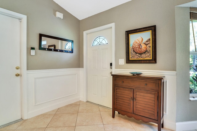 entryway with light tile patterned floors and a wealth of natural light