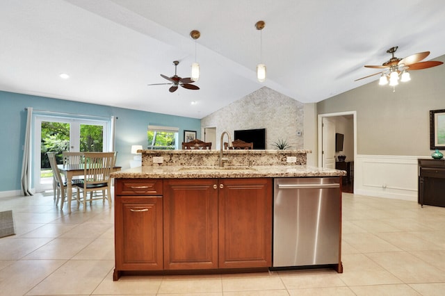 kitchen featuring lofted ceiling, sink, decorative light fixtures, a kitchen island with sink, and dishwasher