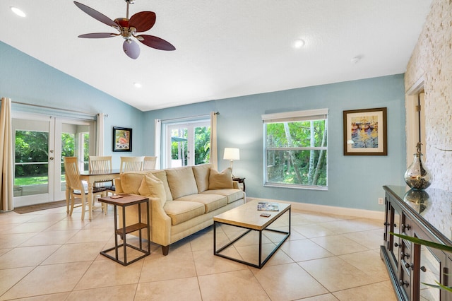 tiled living room with lofted ceiling, french doors, and ceiling fan