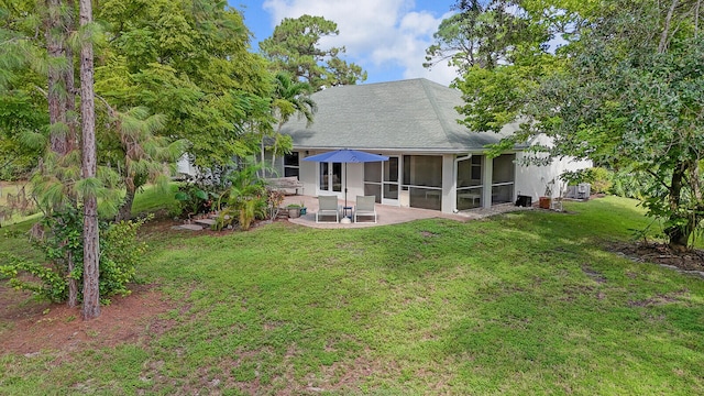 back of house with a sunroom, a yard, and a patio