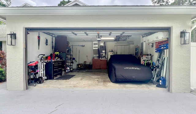 garage with water heater and heating unit