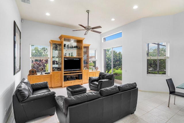 living room with a healthy amount of sunlight, ceiling fan, and light tile patterned floors