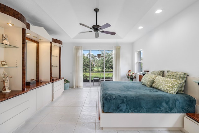 tiled bedroom with a raised ceiling, access to outside, and ceiling fan