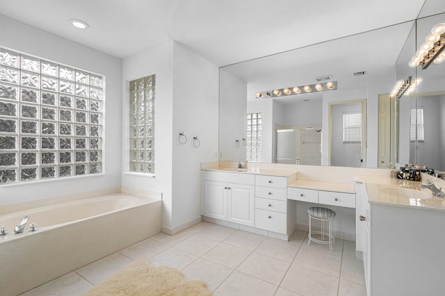 bathroom with tile patterned floors, vanity, and independent shower and bath