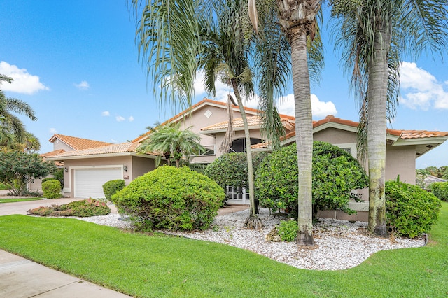 view of front facade with a front lawn and a garage