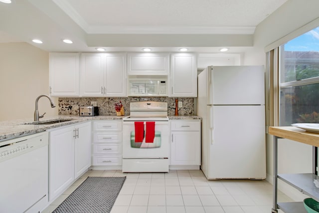 kitchen featuring white appliances, white cabinetry, tasteful backsplash, and sink