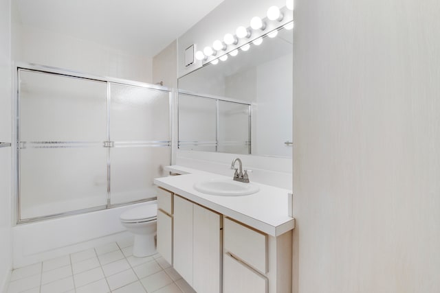 full bathroom featuring vanity, tile patterned flooring, toilet, and combined bath / shower with glass door