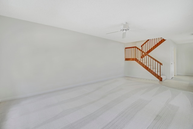 unfurnished living room with light carpet and ceiling fan