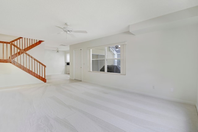 unfurnished living room with light carpet and ceiling fan