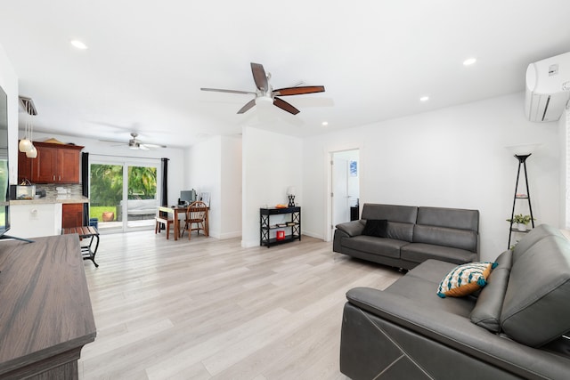 living room with an AC wall unit, light wood-type flooring, and ceiling fan