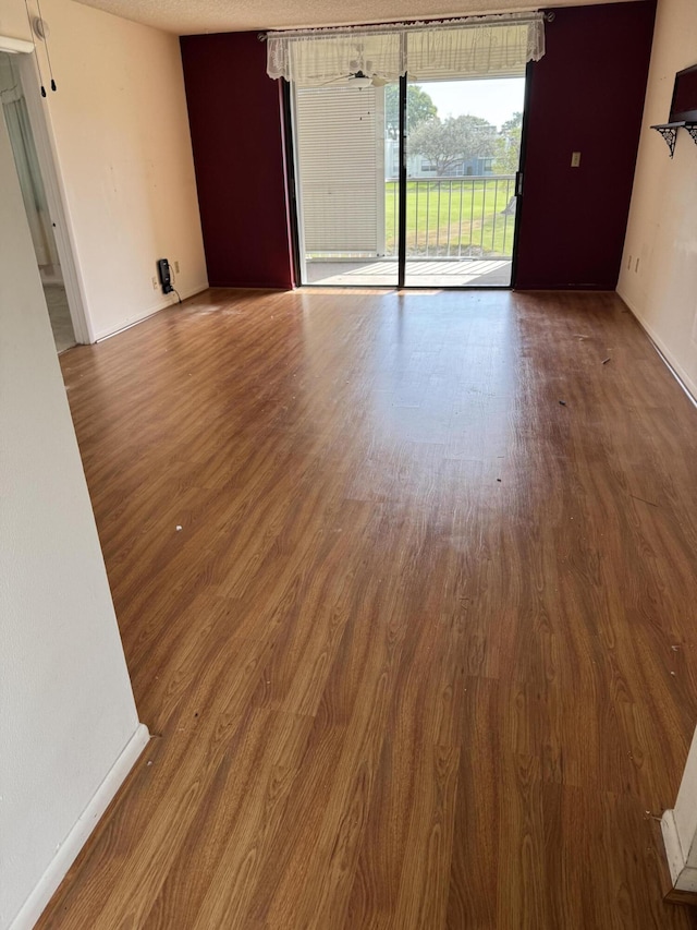 spare room featuring wood-type flooring