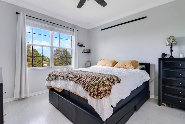 bedroom featuring ceiling fan, light hardwood / wood-style flooring, and ornamental molding