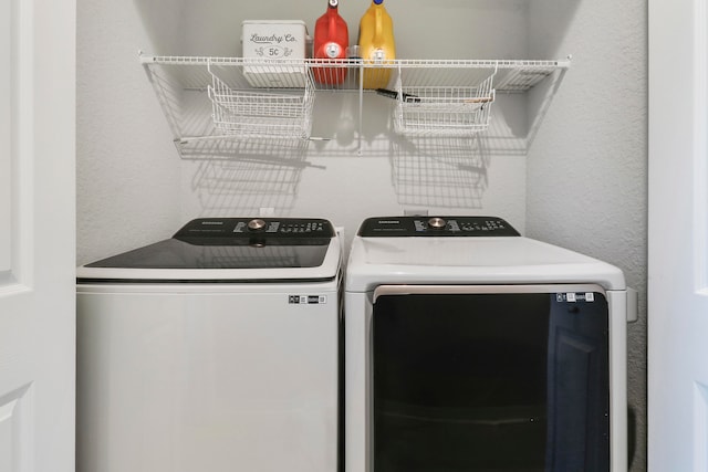 washroom with independent washer and dryer