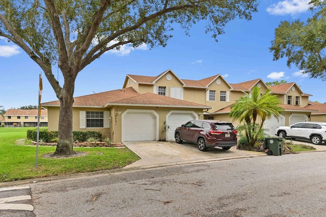 view of front of property with a garage and a front lawn