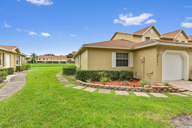 view of home's exterior featuring a lawn and a garage