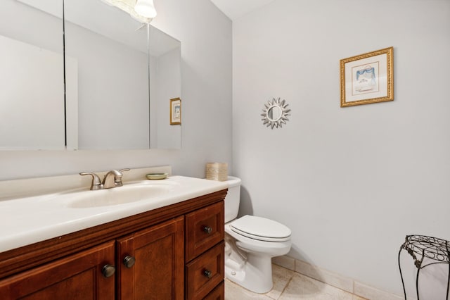 bathroom featuring tile patterned flooring, vanity, and toilet