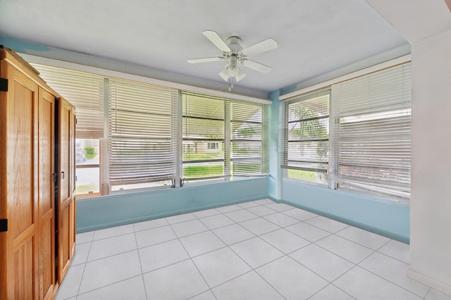 unfurnished sunroom featuring ceiling fan