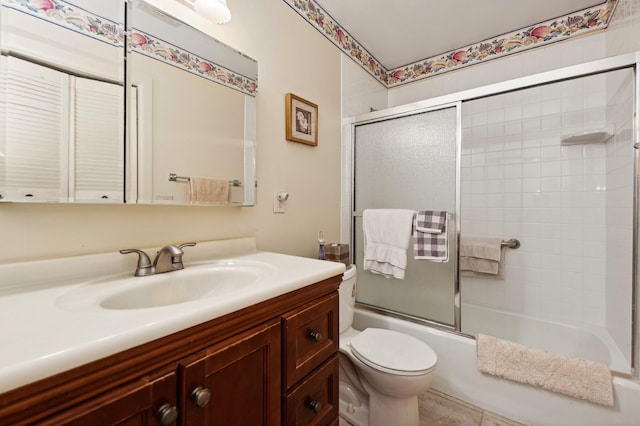 full bathroom featuring vanity, tile patterned floors, toilet, and combined bath / shower with glass door