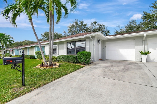 single story home featuring a front lawn and a garage