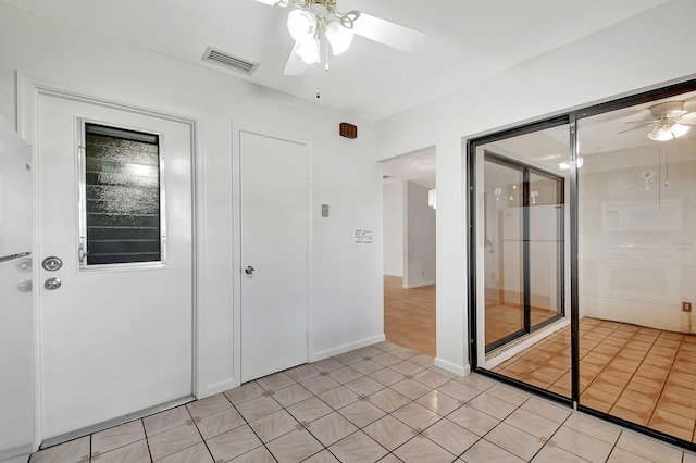 interior space featuring light tile patterned floors and ceiling fan