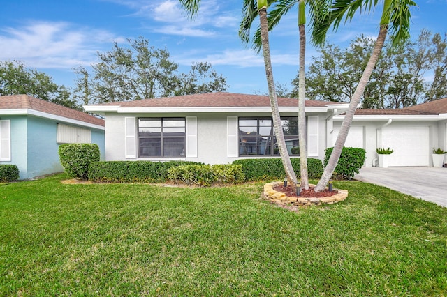 ranch-style home featuring a garage and a front lawn