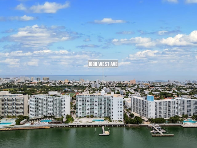 birds eye view of property featuring a city view and a water view