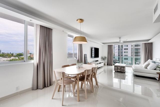1000 W Ave Unit 502, Miami Beach, FL 33139 - dining room with healthy amount of natural light, a ceiling fan, and light tile patterned floors
