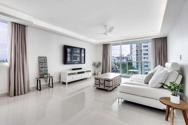 1000 W Ave Unit 502, Miami Beach, FL 33139 - living room with light tile patterned floors, a ceiling fan, and a raised ceiling