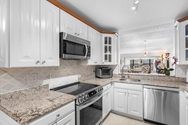 kitchen featuring sink, stainless steel appliances, white cabinets, and light tile patterned floors