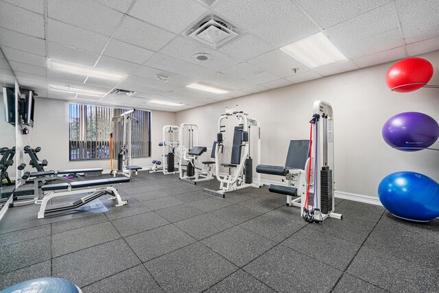 exercise room with a paneled ceiling