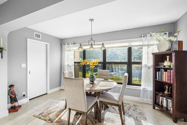 dining area featuring light tile patterned floors and a healthy amount of sunlight