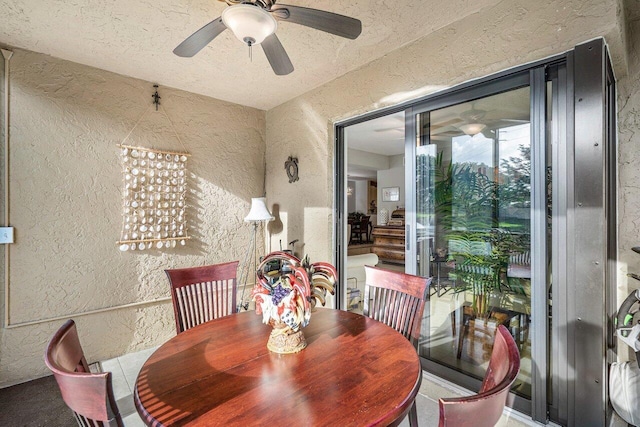 dining area featuring a textured ceiling and ceiling fan