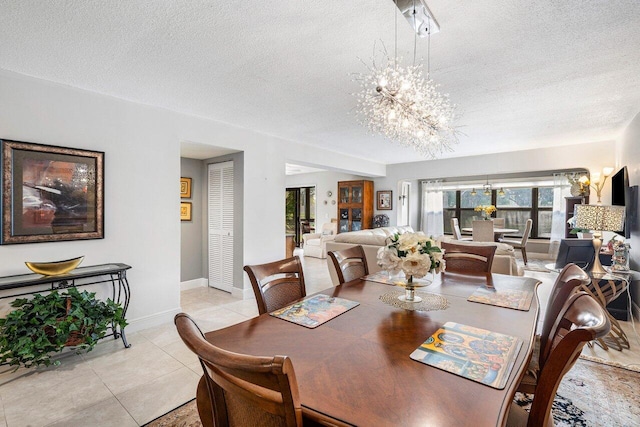 tiled dining area with a textured ceiling and a notable chandelier