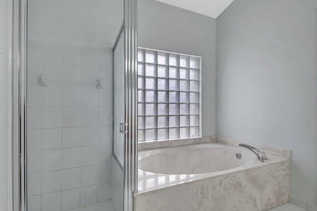 bathroom with shower with separate bathtub and a healthy amount of sunlight