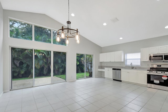 kitchen with appliances with stainless steel finishes, white cabinetry, and sink