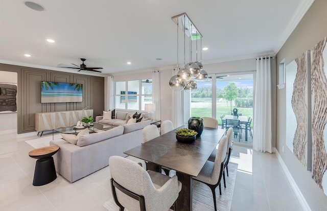 dining room featuring light tile patterned floors, ornamental molding, and ceiling fan