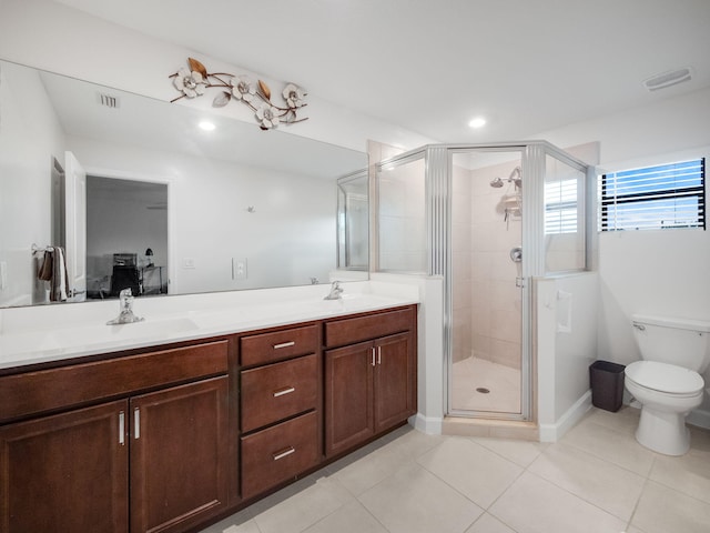 bathroom with tile patterned floors, vanity, an enclosed shower, and toilet