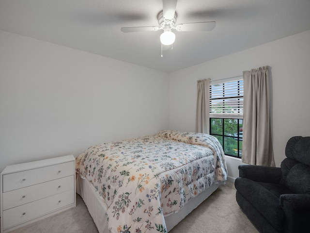 bedroom featuring light colored carpet and ceiling fan